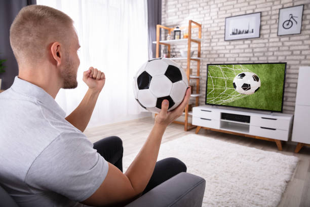 istock Man Watching Football Match On Television 1069502730