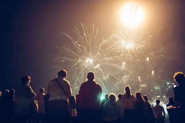 istock Crowd watching fireworks and celebrating new year eve 1069503222