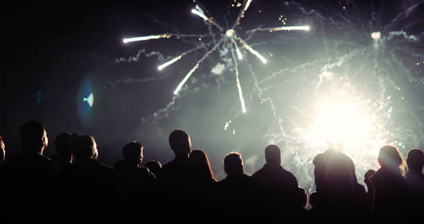 istock Crowd watching fireworks and celebrating new year eve 1069503280