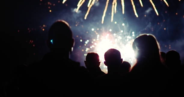 istock Crowd watching fireworks and celebrating new year eve 1069503364