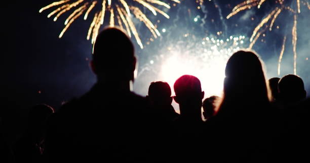 istock Crowd watching fireworks and celebrating new year eve 1069503366