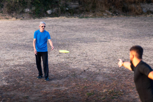 istock Men playing frisbee in the park 1069503600