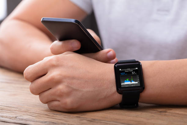 istock Man With Mobile And Smartwatch Showing Heartbeat Rate 1069503860