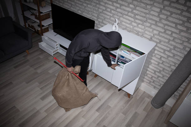 Thief Stealing File From Shelf Elevated View Of Thief With Crowbar And Sack Stealing File From Shelf burglary photos stock pictures, royalty-free photos & images