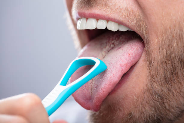 istock Man Cleaning His Tongue 1069504624