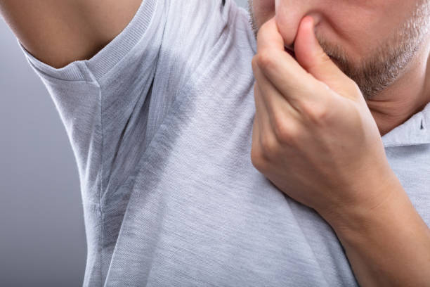 istock Man With Sweaty Armpit Covering His Nose 1069504698