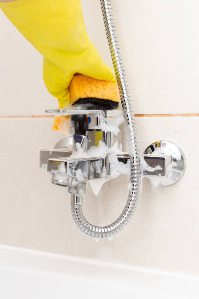 istock Person cleaning water tap 1069506500