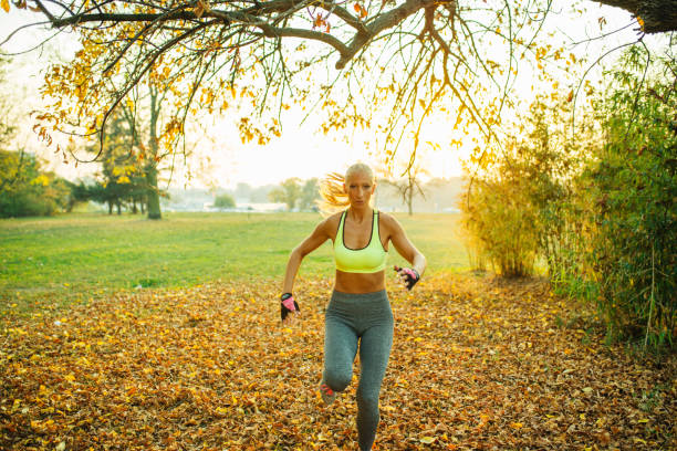 istock Blonde running in the park 1069506946