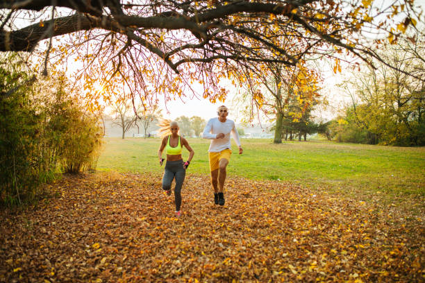 istock Couple jogging in autumn nature 1069507398