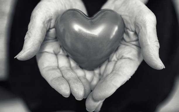 istock elder woman holding heart 1069511252