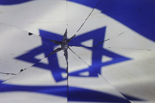 Israel flag is reflected in broken mirror