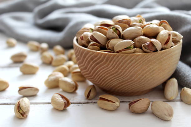 Pistachios nuts on wooden background. stock photo