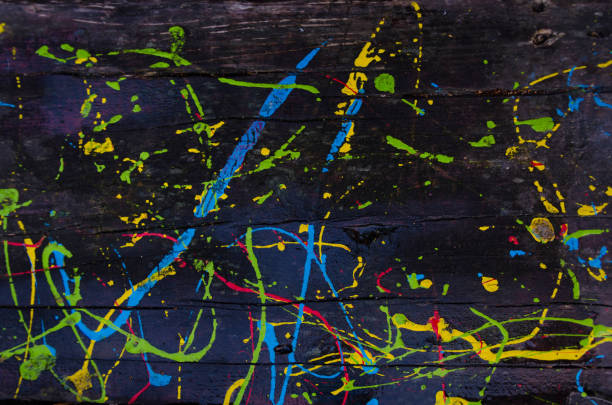 istock Kids scribbles on a wooden table with colorful oil paints. Background. 1069516534