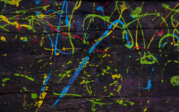 istock Kids scribbles on a wooden table with colorful oil paints. Background. 1069516542