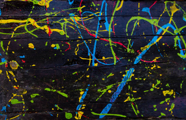 istock Kids scribbles on a wooden table with colorful oil paints. Background. 1069516548