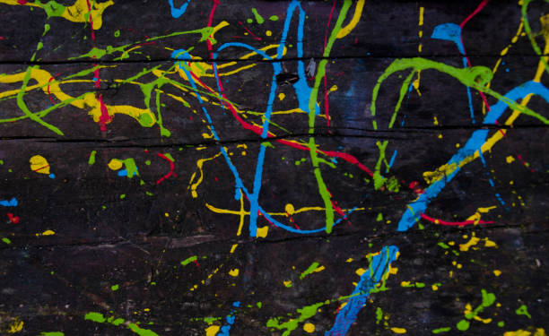 istock Kids scribbles on a wooden table with colorful oil paints. Background. 1069516566
