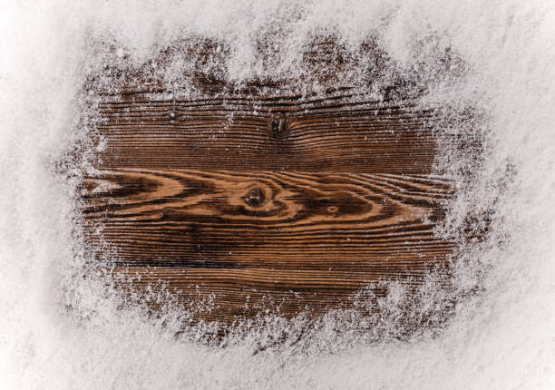 istock Christmas snow frame on wooden background 1069517278