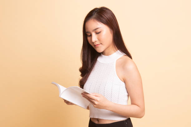 istock Young Asian woman read a book. 1069520692