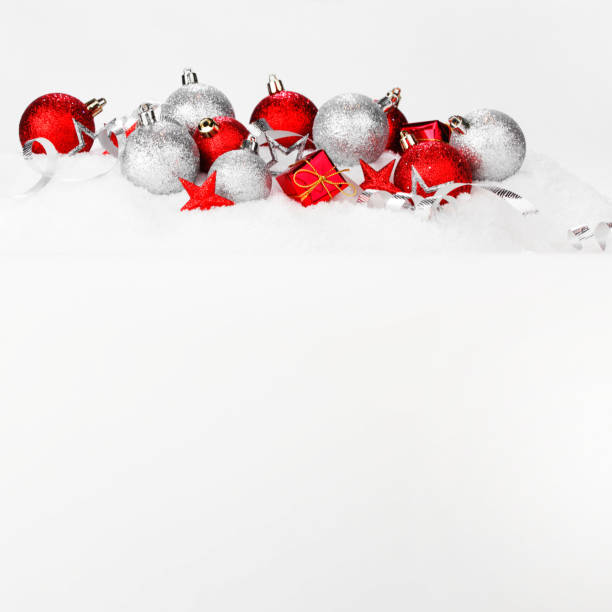 istock Red and silver christmas balls and decoration on snow 1069522958