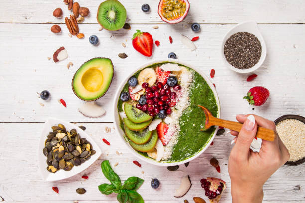 istock Smoothie bowl with fresh berries, nuts, seeds, fruit and vegetables. 1069527778