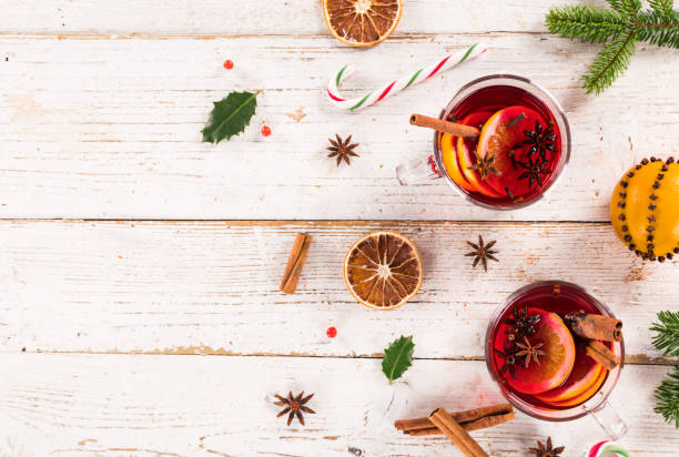 istock Christmas hot mulled wine with spices on wooden background. 1069528086