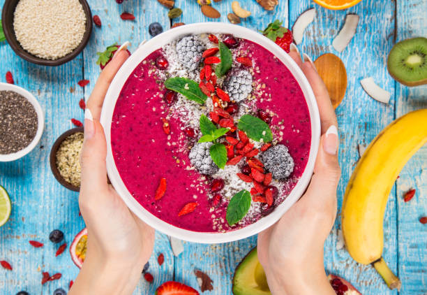 istock Smoothie bowl with fresh berries, nuts, seeds, fruit and vegetables. 1069529330