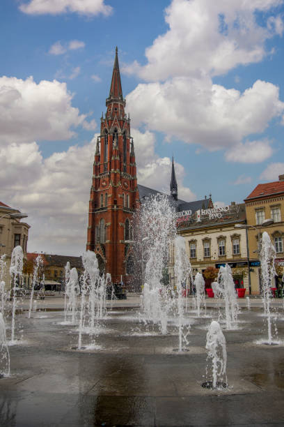Scenic view of fountain on the main square and catholic St Peter and Paul Cathedral in the background. Osijek, Croatia - Nov 3, 2018: Scenic view of fountain on the main square and catholic St Peter and Paul Cathedral in the background. osijek photos stock pictures, royalty-free photos & images
