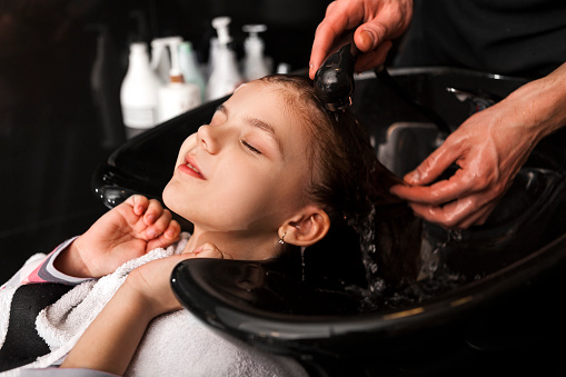 Little girl getting hair wash