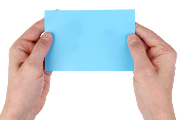 istock Elderly man grandfather holding empty blue paper page  card in hands. Isolated 1069532818