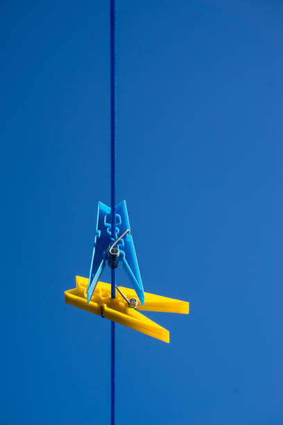 istock Colourful cloths pegs on washing line with blue sky background. 1069534484
