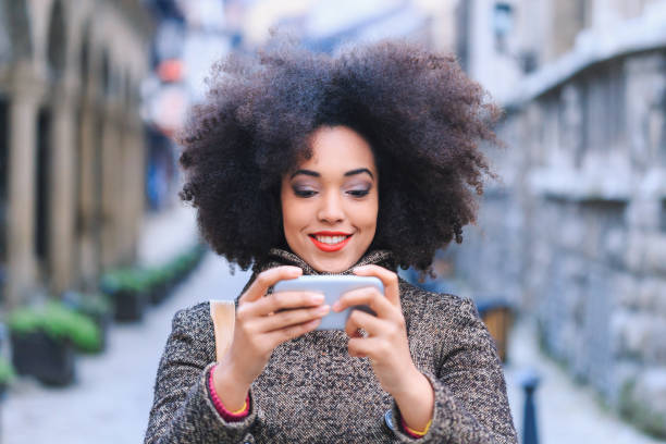 istock Smiling tourist taking selfie on street 1069535538