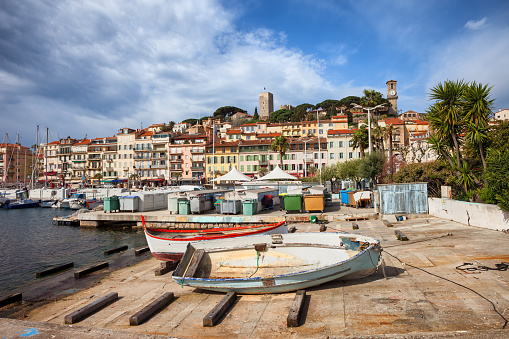 Cannes city skyline on French Riviera in France, Le Suquet old town from quay of Le Vieux port