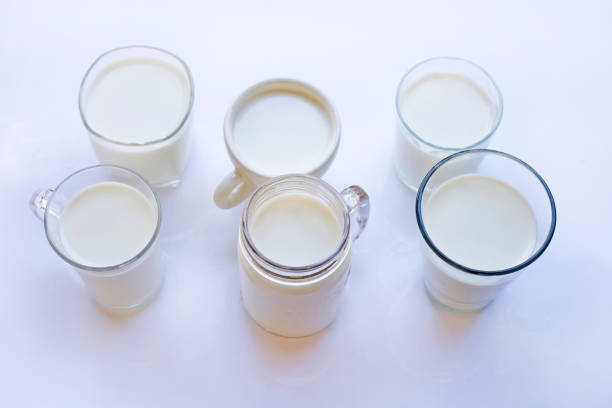 istock Cup and glass of milk on white background 1069537326