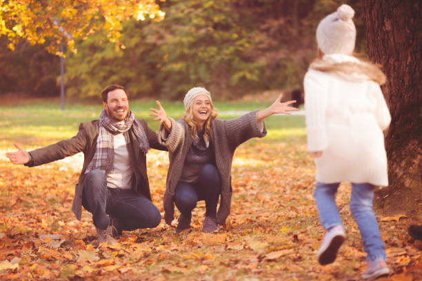 istock Daughter running to hug her parents 1069538834