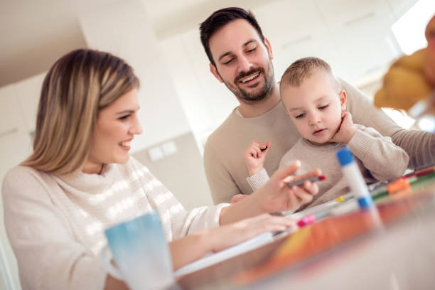 istock Mother and father drawing together with their child 1069542162