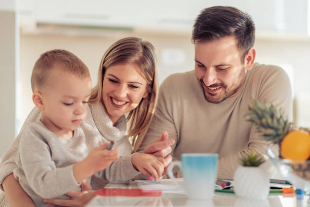 istock Mother and father drawing together with their child 1069542528