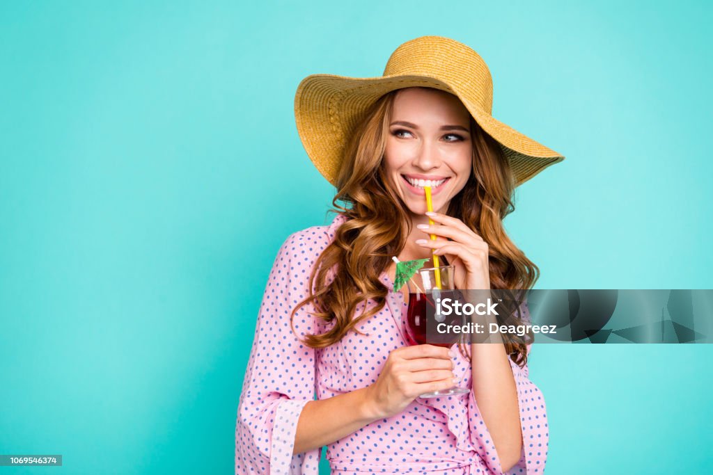 Attractive pretty lovely cute sweet gorgeous lady with panama on head her style stylish curly wave trendy hairdo she look aside hold beverage in hands isolated on bright turquoise background Women Stock Photo