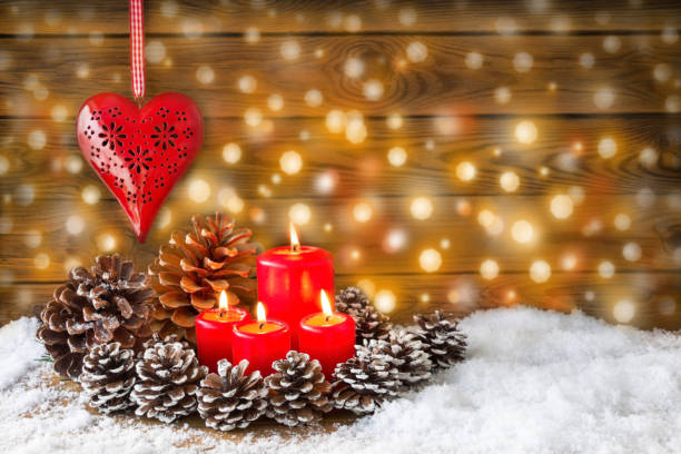 istock Christmas background with four red candles and heart 1069547698