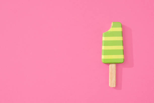 istock Striped ice lollipop popsicle on pink 1069553894