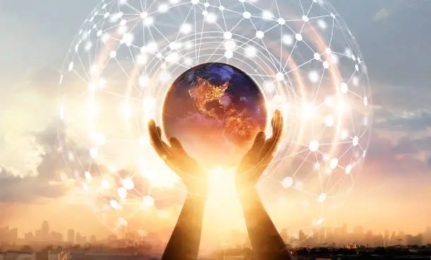 Photo of Abstract science. Hands touching earth and circle global network connection, data exchanges worldwide on city sunset background. Innovation. Creative and inspiration. Idea and imagination. Networking and technology concept. Elements of this image furnishe