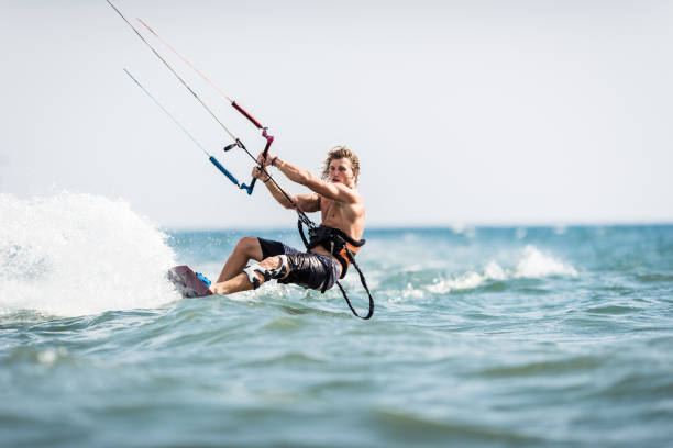istock Athletic man having fun while kitesurfing on the sea. 1069554624