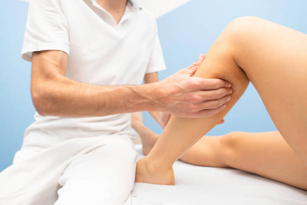 istock Delicate calf massage in a professional physiotherapist's studio 1069556544