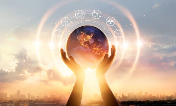 istock Abstract palm hands touching earth at night on sunset city background. Earth day. Energy saving concept, Elements of this image furnished by NASA 1069557302