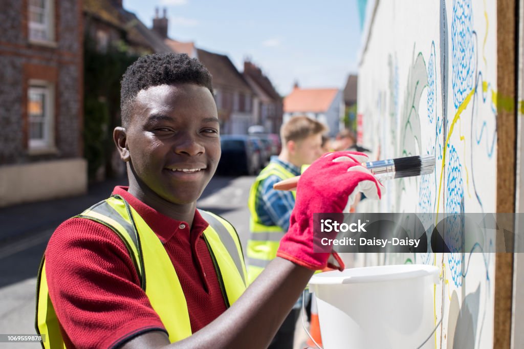 Group Of Helpful Teenagers Creating And Maintaining Community Art Project Community Stock Photo