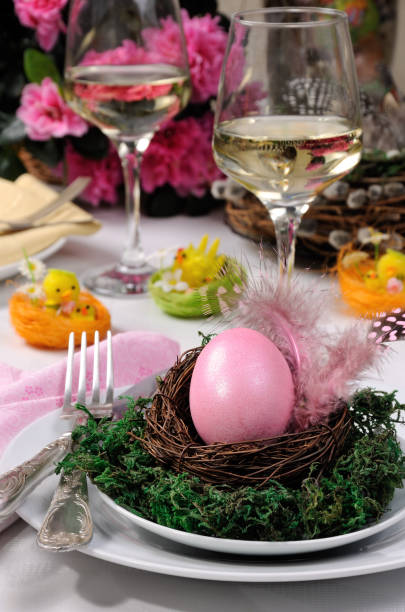 istock Decorative serving of the table for Easter. A painted egg in a nest on a plate with moss 1069559988