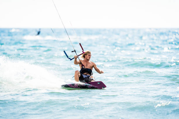 istock Young man kiteboarding during summer day at sea. 1069560282