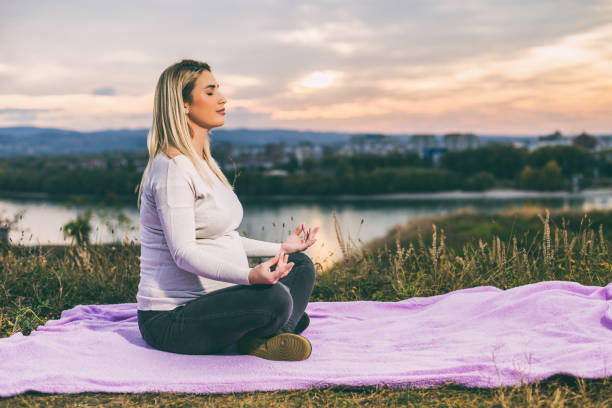 istock Pregnant woman meditating 1069560410