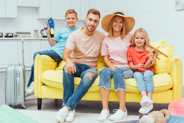 istock family resting on sofa after packing for summer vacation, travel concept 1069562108