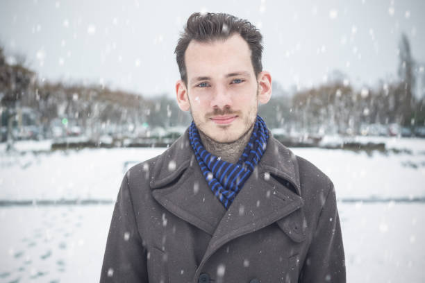 istock A young handsome male with beard and moustache in winter snow 1069563000