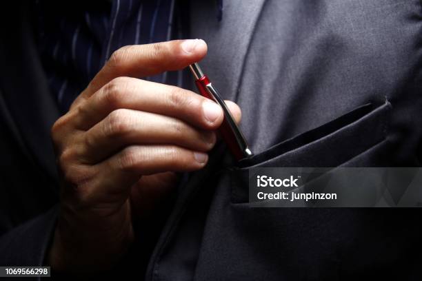 Man Inserting A Pen To His Suits Pocket Stock Photo - Download Image Now - Pen, Pocket, Suit